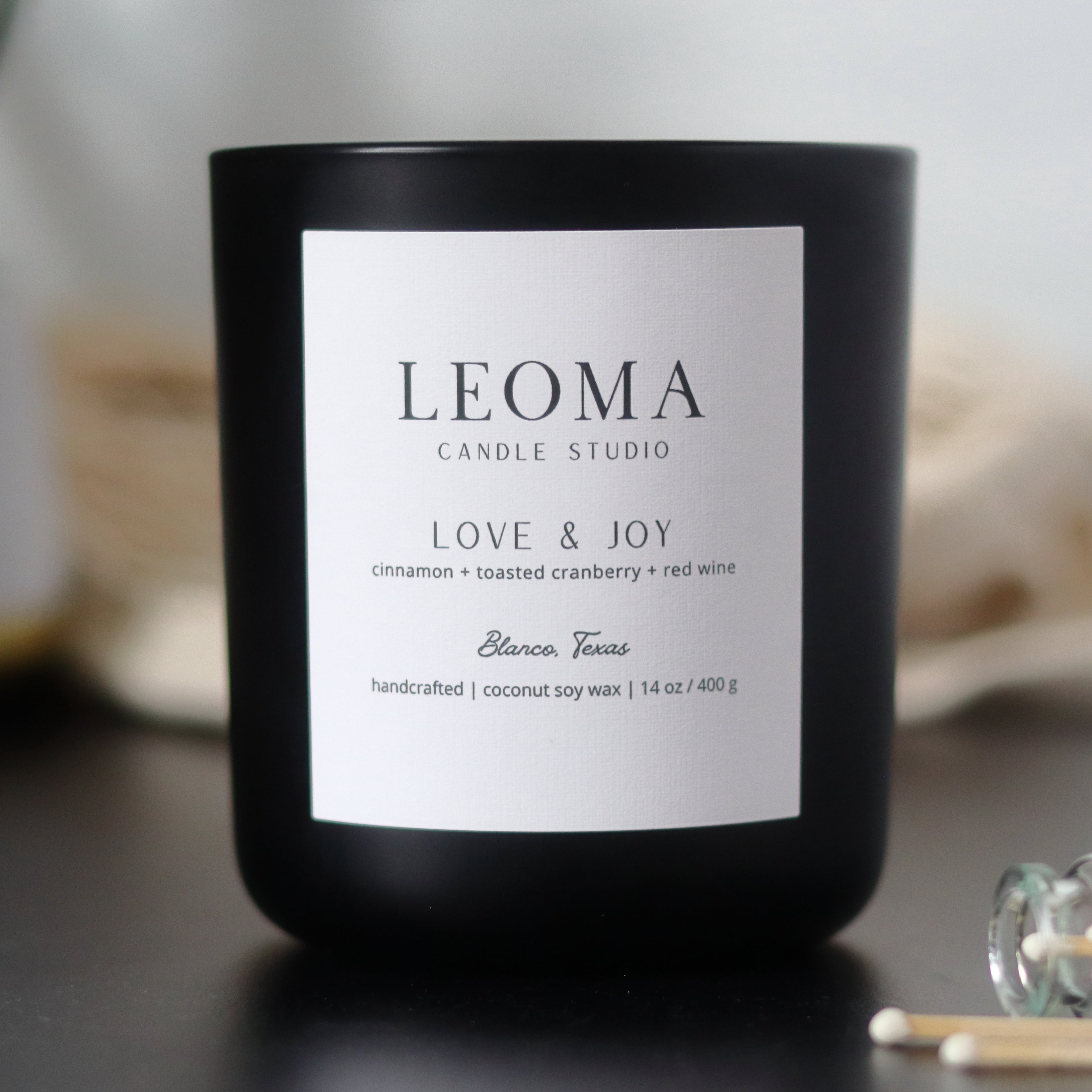 Handcrafted eco-friendly scented candle. Natural coconut & soy wax, toxin-free, 100% cotton wicks. Black vessel. Love & Joy scent.