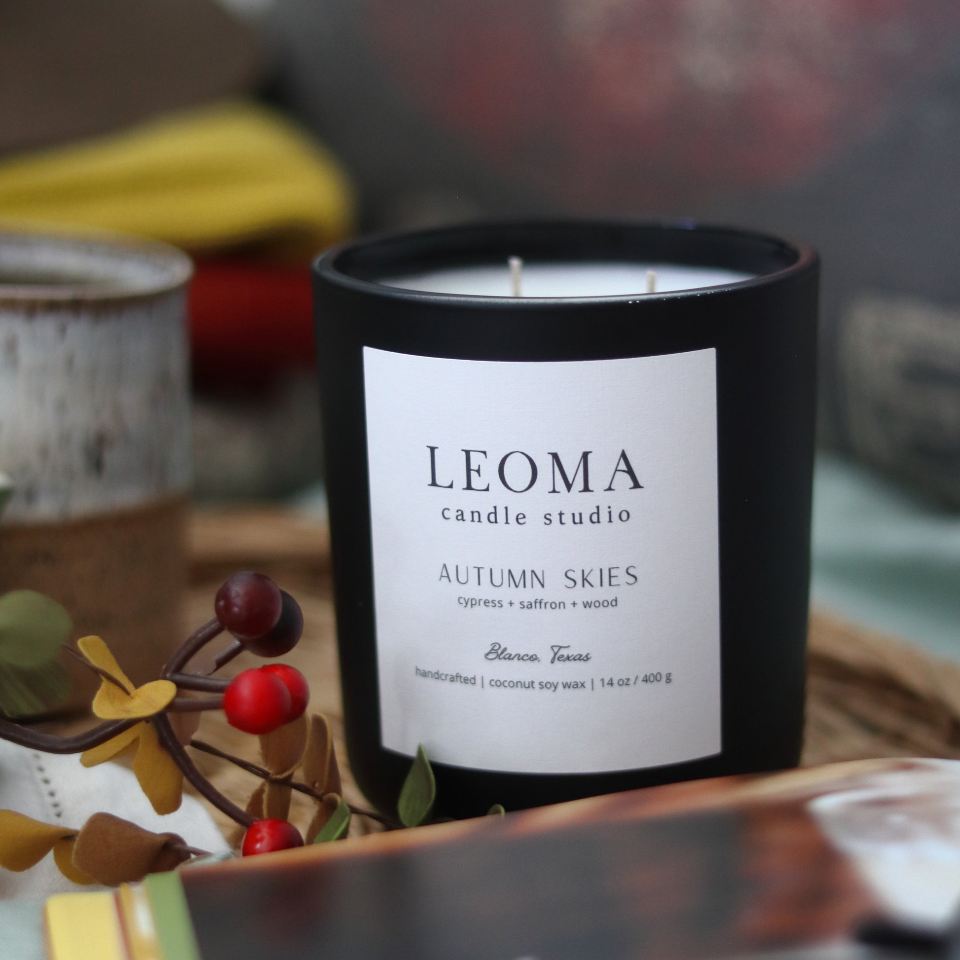 Scented natural soy candle. non toxic. Autumn Skies fall scent. Black vessel. close.