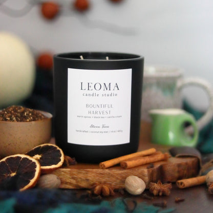 Handcrafted natural soy candle. Non toxic. 100% cotton wicks. black vessel. Bountiful Harvest scented. front