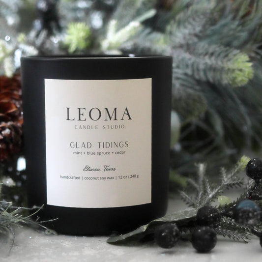 Handcrafted eco-friendly scented candle. Natural coconut & soy wax, toxin-free, 100% cotton wicks. Black vessel. Glad Tidings scented.
