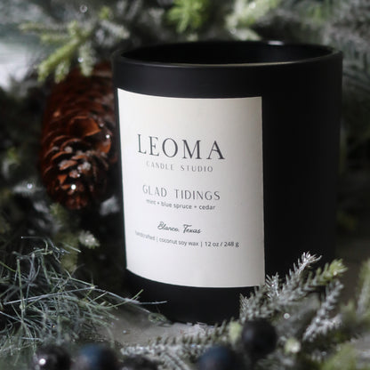 Handcrafted eco-friendly scented candle. Natural coconut & soy wax, toxin-free, 100% cotton wicks. black vessel. Glad Tidings scented.