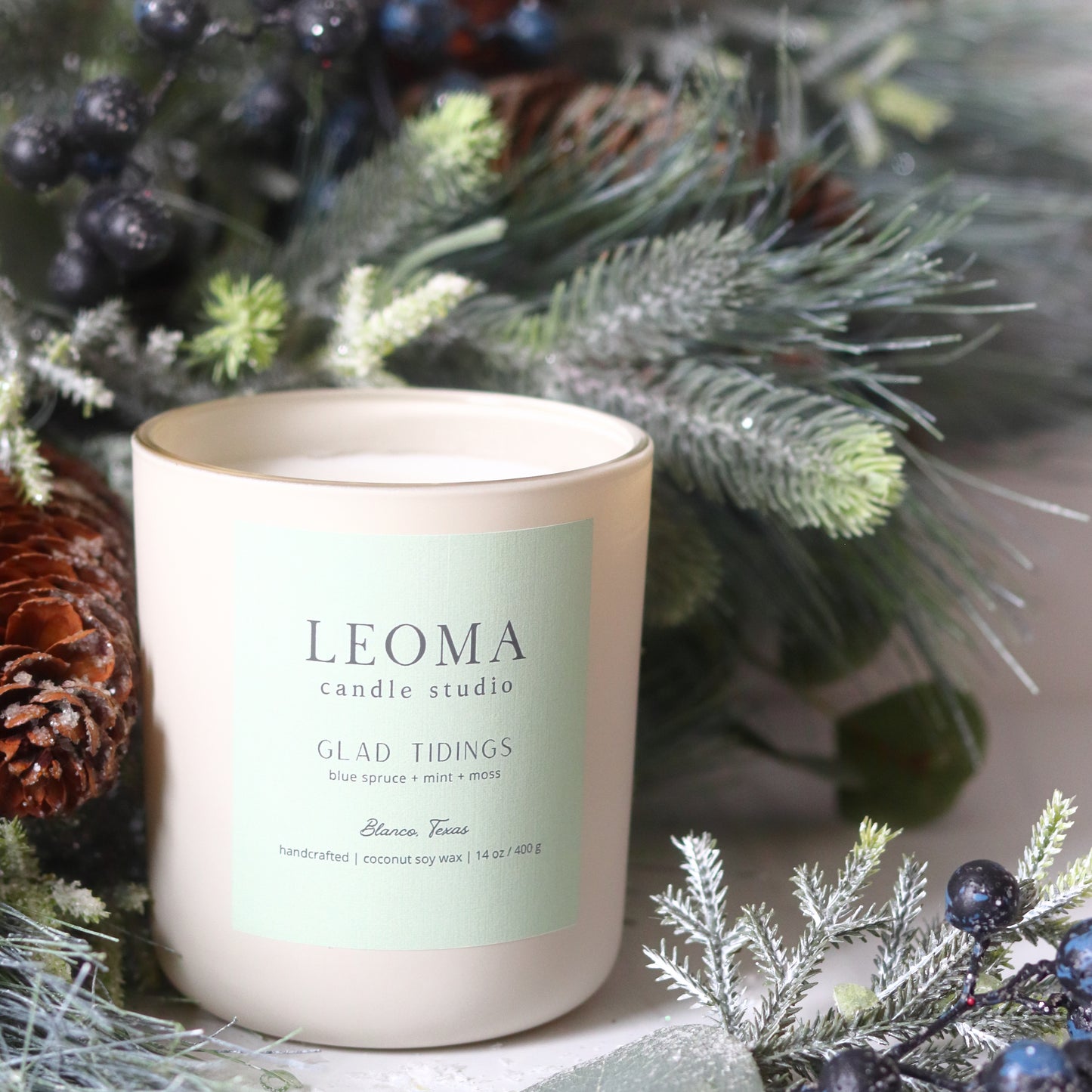 Handcrafted eco-friendly scented candle. Natural coconut & soy wax, toxin-free, 100% cotton wicks. cream vessel. Glad Tidings scented.