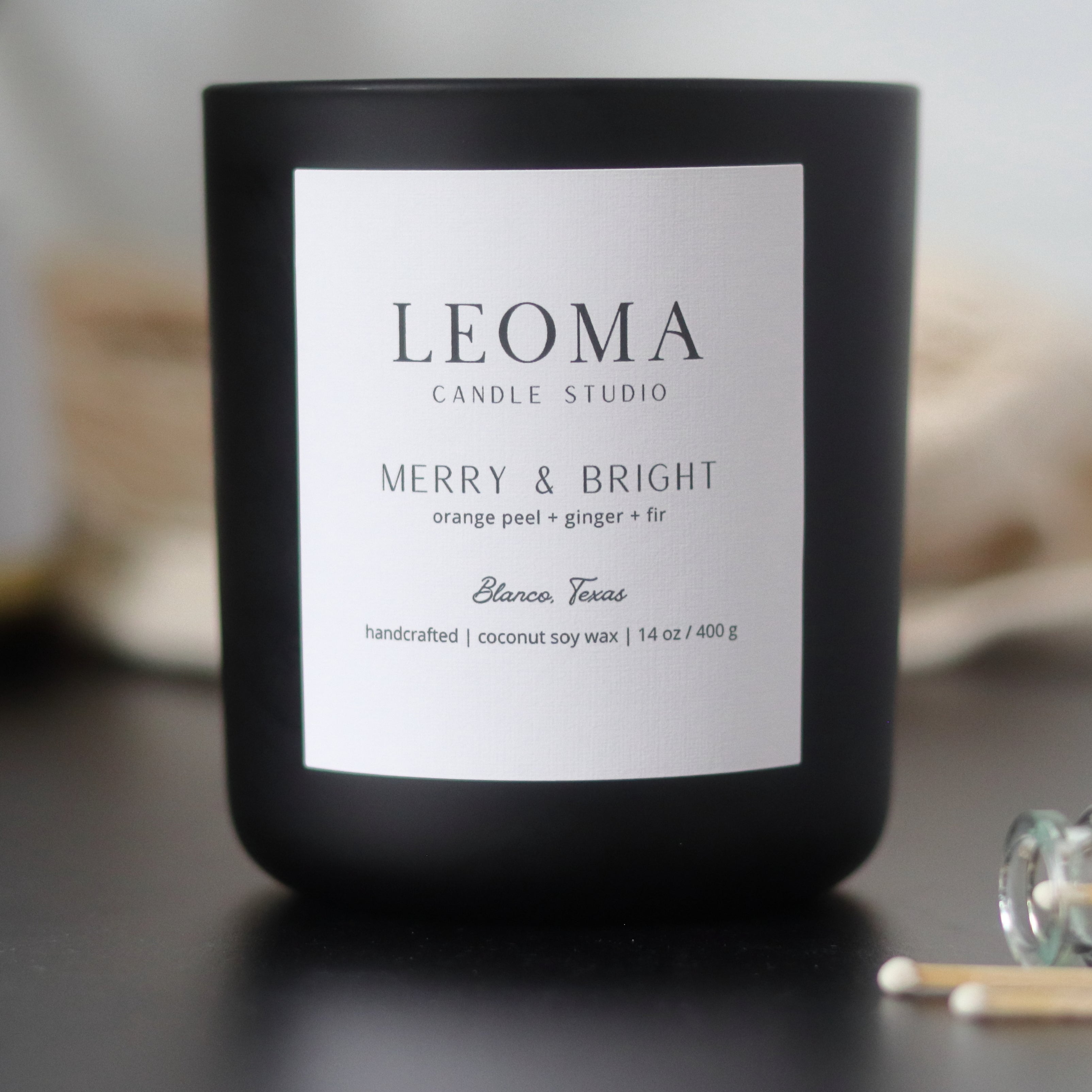 Handcrafted eco-friendly scented candle. Natural coconut & soy wax, toxin-free, 100% cotton wicks. Black vessel. Merry and Bright scented.